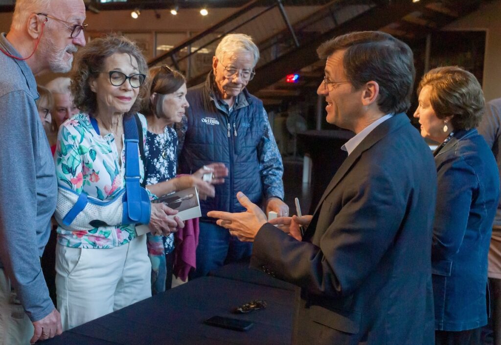 Peter Baker, New York Times' chief White House correspondent and Susan Glasser, staff writer and columnist for The New Yorker, chat with audience members after a presentation on journalism in the Trump era at the Center for the Arts in Jackson on July 23, 2025. (Angus M. Thuermer Jr./WyoFile)